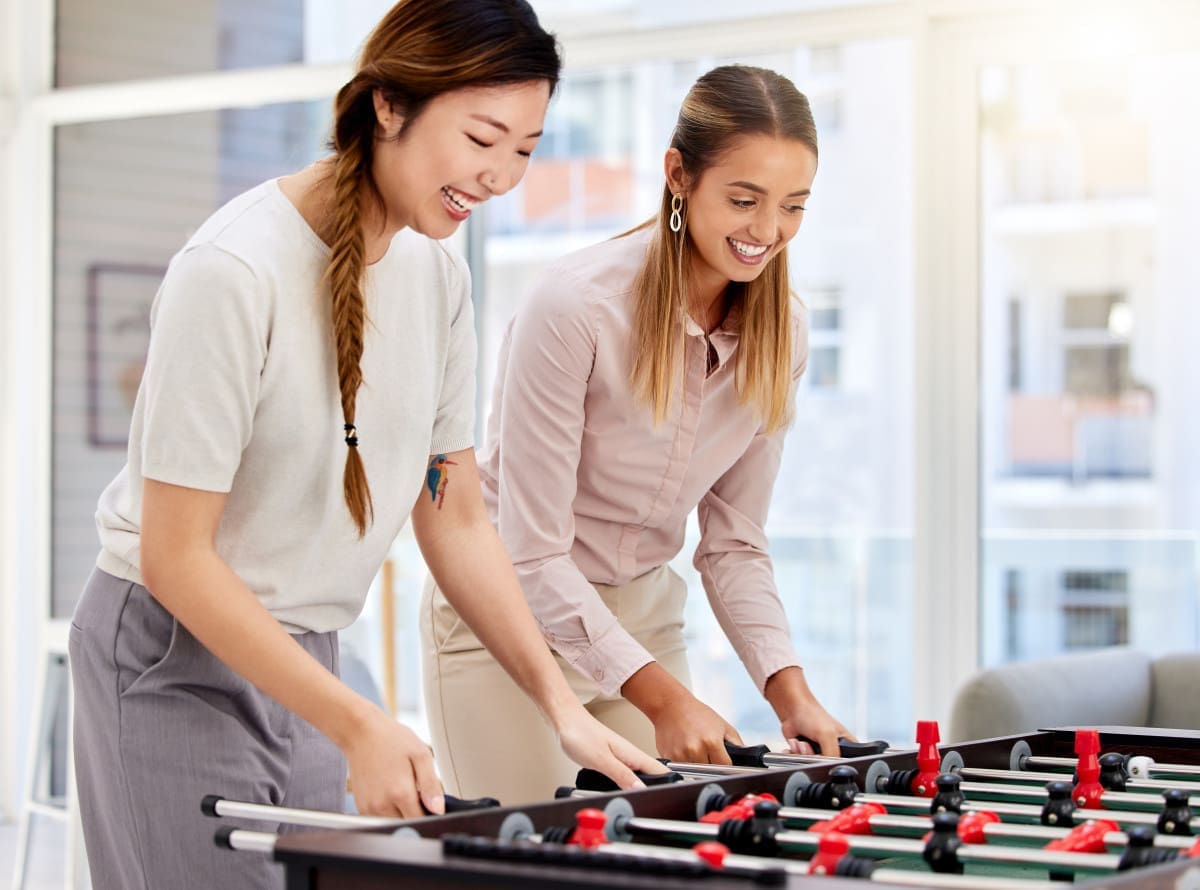happy-employee-playing-table-soccer-laughing-