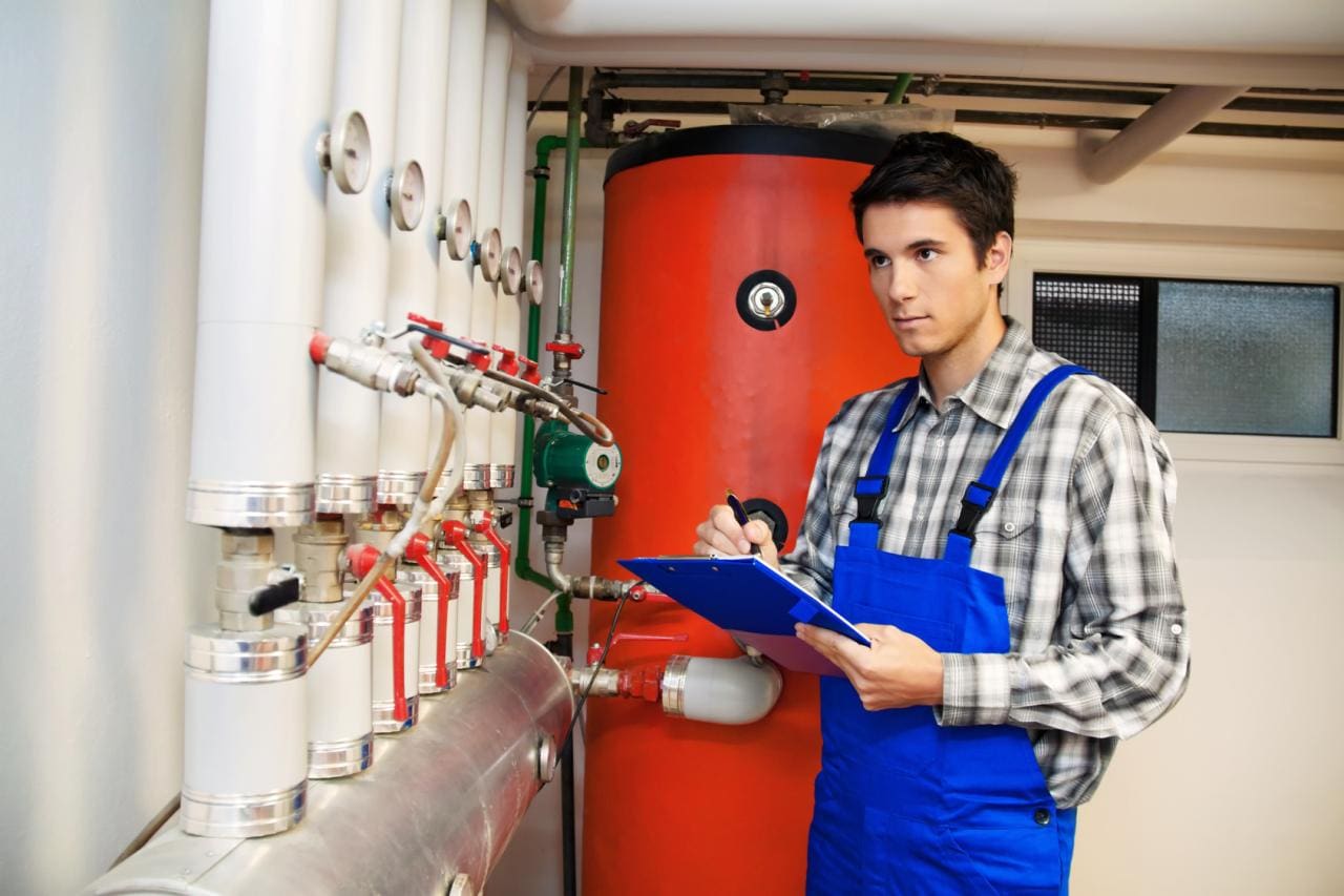Jeune technicien d'une entreprise de chauffage dans la chaufferie